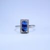Ring with Blue Sapphire Baguette Cut Accent and Dazzling Halo