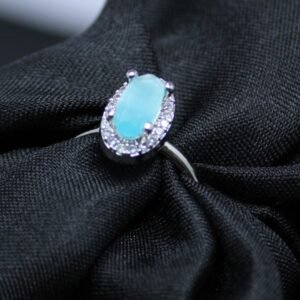 Elegant Sky Blue Oval Cut Silver Ring with Diamond Halo Accents