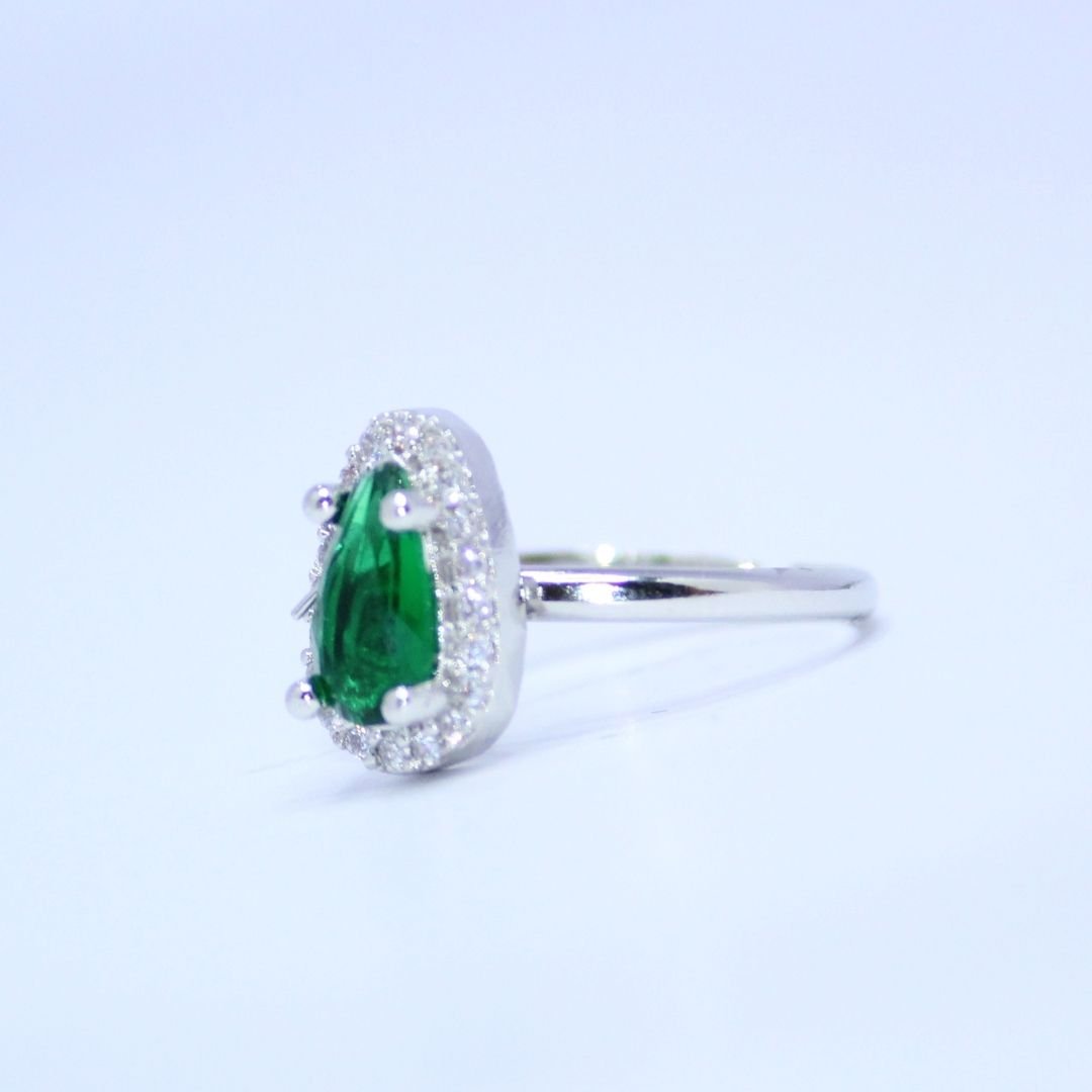 3 Radiant Pear Cut Emerald Green Accent Ring with a Sparkling Halo of Brilliance Radiant Pear Cut Emerald Green Accent Ring with a Sparkling Halo of Brilliance