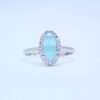Elegant Sky Blue Oval Cut Silver Ring with Diamond Halo Accents