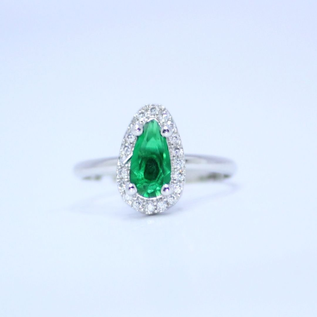 Radiant Pear Cut Emerald Green Accent Ring with a Sparkling Halo of Brilliance