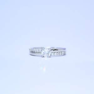 timeless solitaire ring with a pavé-accented band