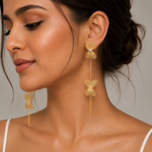 Model wearing 22K gold-tone plated butterfly cascade statement earrings